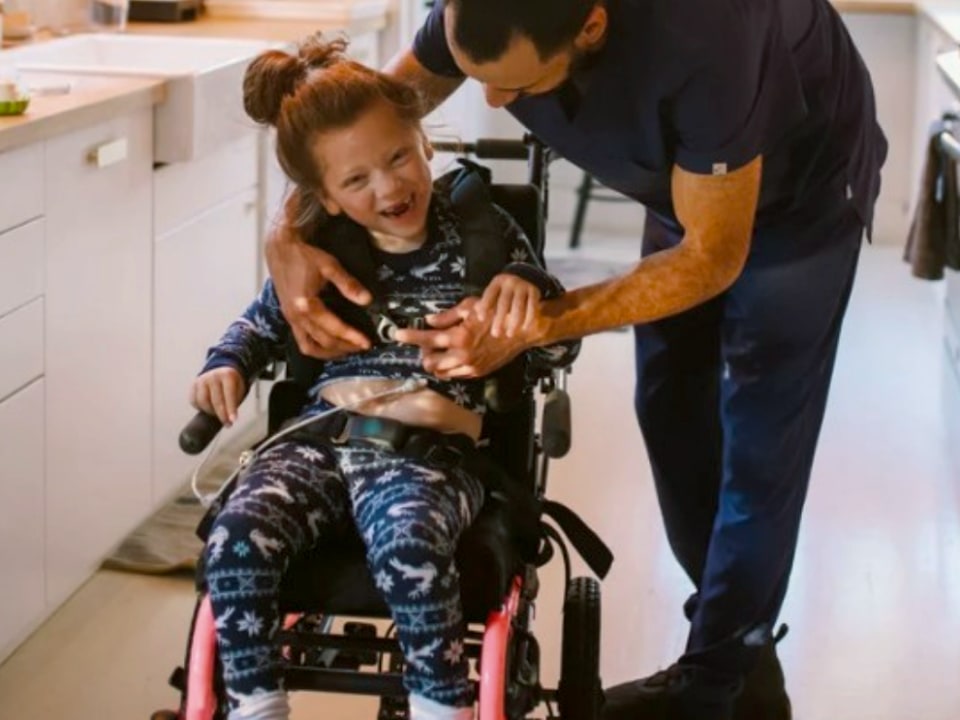 Nurse With Child in a wheelchair.