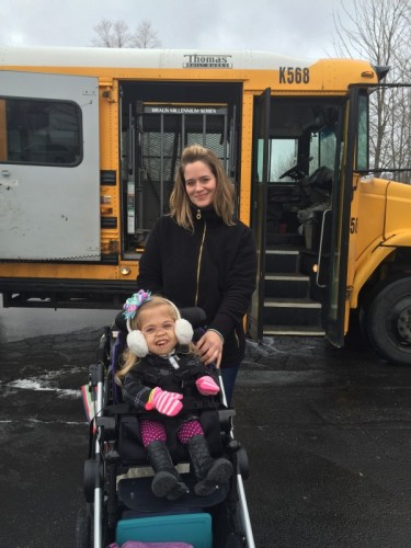 Child in a wheelchair getting off a School Bus.